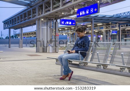 A woman waiting in the railway station.