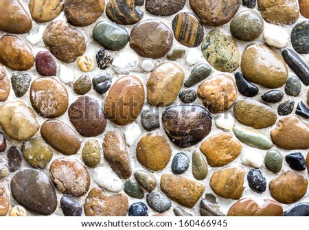 Wet round stone rock texture with tiny water drops on them and dramatic lighting