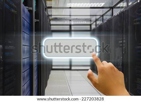 Hand press on window icon in data center server room.