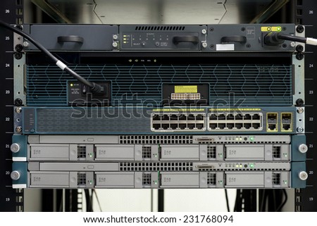 Server computer and power on ethernet switch install on rack in data center room.