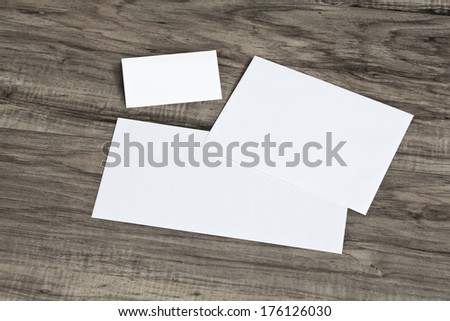 Blank corporate identity template package business card envelope & letter on wood floor.