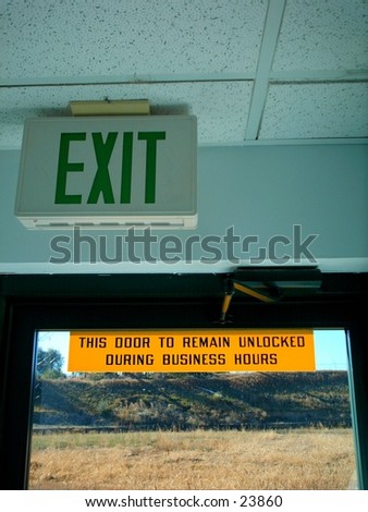 Two signs, Exit sign next to outside door with a sign that reads \