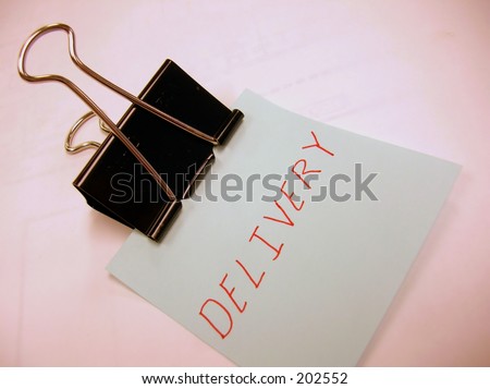 Binder clip holding blue note saying \