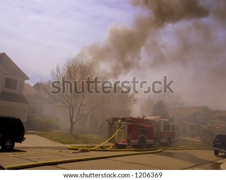 Fire truck and firemen at scene of house fire #13