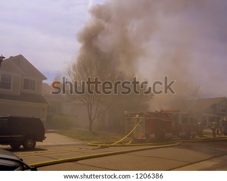 Fire truck and firemen at scene of house fire #30