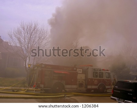 Fire truck and firemen at scene of house fire #28
