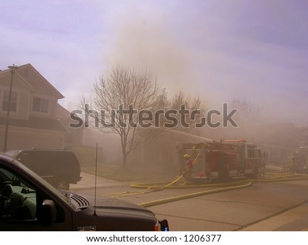 Fire truck and firemen at scene of house fire #21