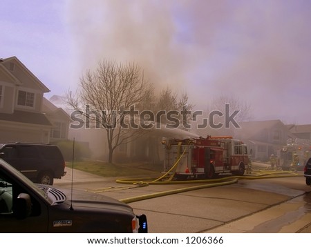 Fire truck and firemen at scene of house fire #10