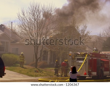 Fire truck and firemen at scene of house fire #11