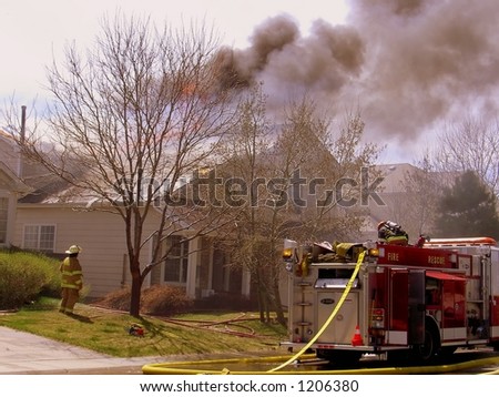 Fire truck and firemen at scene of house fire #24