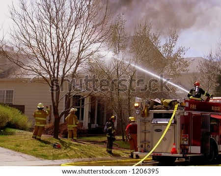 Fire truck and firemen at scene of house fire #38
