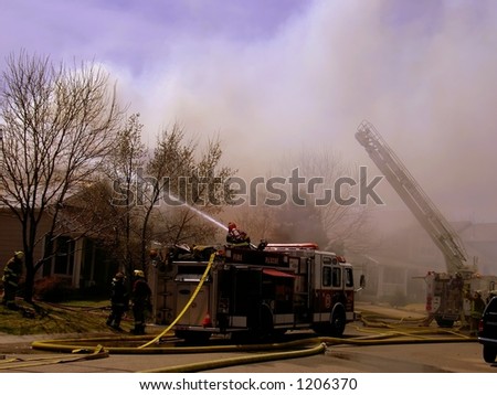 Fire truck and firemen at scene of house fire #14