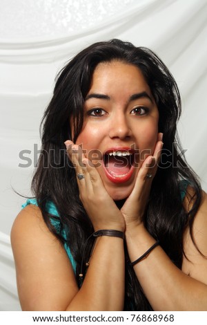 A lovely teenage Latina with a friendly excited and surprised facial