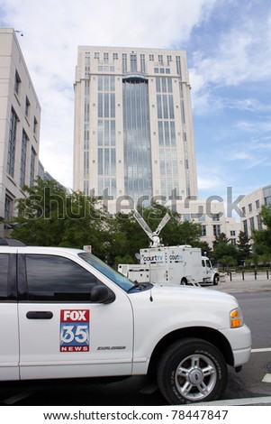 ORLANDO, FL - JUNE 1: A court TV production truck and a Fox 35 news vehicle in front of the Orange County Courthouse, covering the trial of Casey Anthony in Orlando, FL, June 1, 2011.