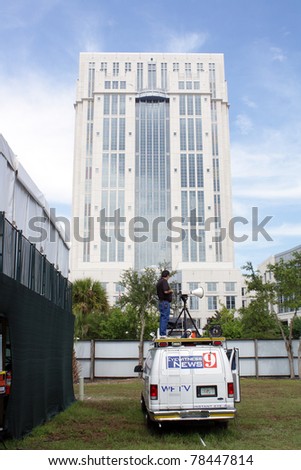 ORLANDO, FL - JUNE 1: A local TV news crew person in front of the Orange County Courthouse, covering the much-publicized trial of Casey Anthony in Orlando, FL, June 1, 2011.