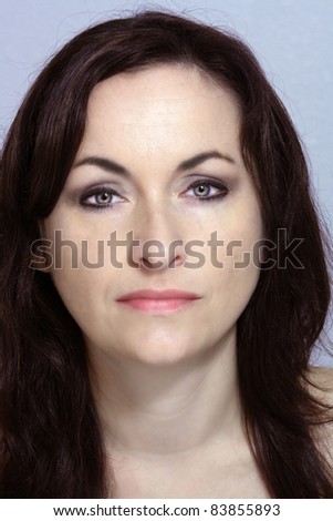 Headshot of a lovely brunette with a neutral facial expression.