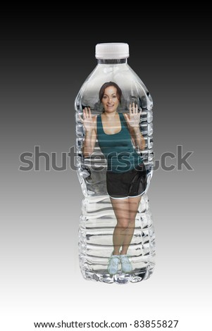 A lovely brunette wearing fitness wear, inside a generic bottle of water.   Generous copyspace.