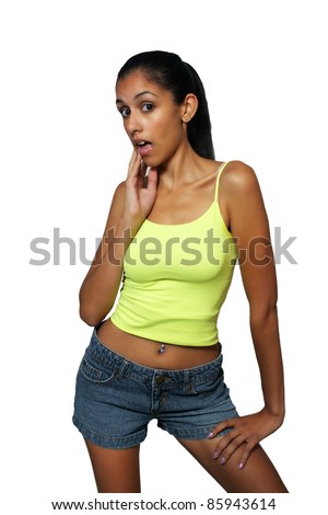 A lovely young, exotic woman with a surprised or doubtful facial expression and wearing denim shorts and a lime-green tank top.  Isolated on a white background with generous copyspace.