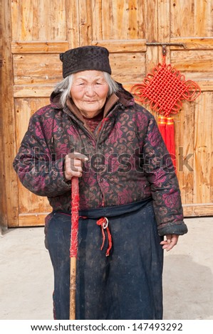 Elderly Chinese woman on crutches