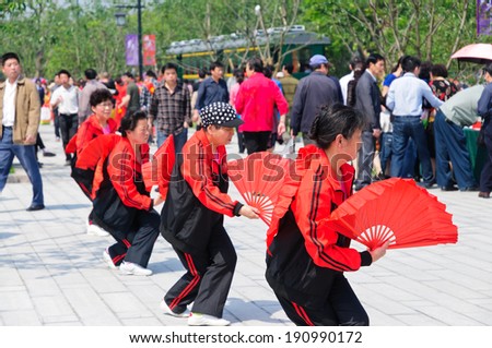 Hangzhou - May 1: people fan dancing in the park. On May 1, 2014, in hangzhou, China. Hangzhou is a leisure city.
