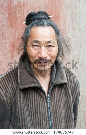 ANHUI, CHINA - JUNE 10: Taoist temple before a close shot portrait of Taoist priest, on June 10, 2013 in anhui province, China.