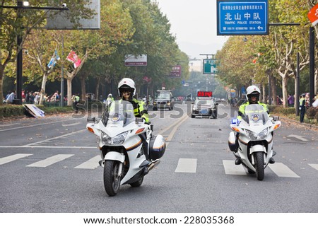 Hangzhou - November 2: international marathon Chinese police car in the guides, on November 2, 2014 in hangzhou, China. Hangzhou international marathon is one of the most important game in China.