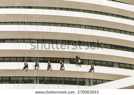 Beijing, China - March 22, 2015:Galaxy SOHO , Cleaner in cleaning walls. Galaxy SOHO is Collection of commercial office in a large building  , Beijing famous landmarks