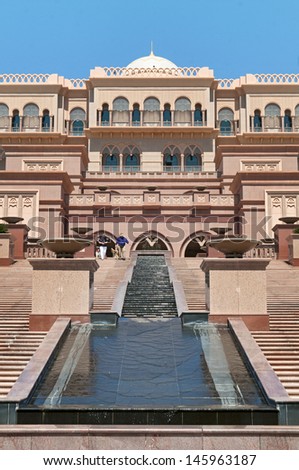 ABU DHABI, UAE - MARCH 17: People coming out from Emirates Palace hotel on March 17, 2010. Emirates Palace is a luxurious and the most expensive 7 star hotel designed by John Elliott RIBA.