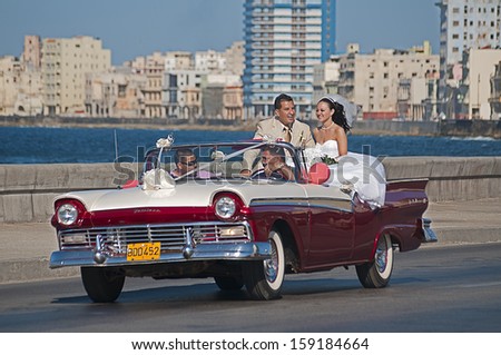 La Habana, Cuba - April 22, 2009. A couple being driven around town before their wedding on April 22, 2009 in La Habana, Cuba. As per tradition, they must visit most popular places, such as Malecon.