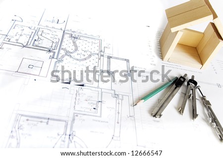 blueprint and wooden model of house