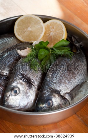 Fresh Sea Bream fish close up with vegetables