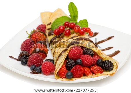 Crepes With Berries and cup of coffee . Crepe with Strawberry, Raspberry, Blueberry and Chocolate topping. Pancake