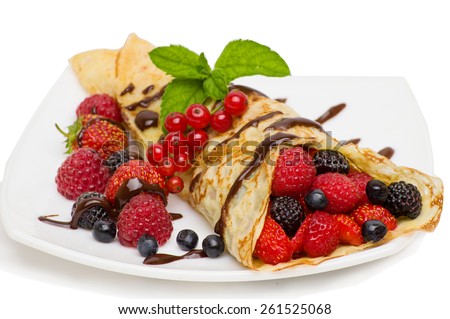 Crepes With Berries and cup of coffee .Crepe with Strawberry, Raspberry, Blueberry and Chocolate topping.Pancake