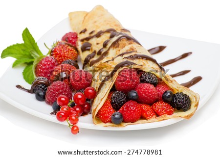 Crepes With Berries and cup of coffee .Crepe with Strawberry, Raspberry, Blueberry and Chocolate topping.Pancake