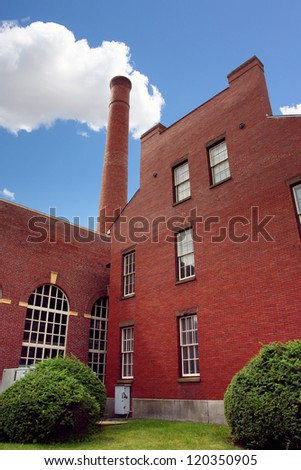 Old brick factory with a tube