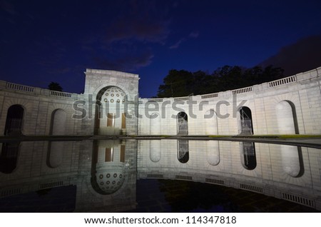 Arlington National Cemetery entrance at night with mirror reflection on the pool, near to Washington DC