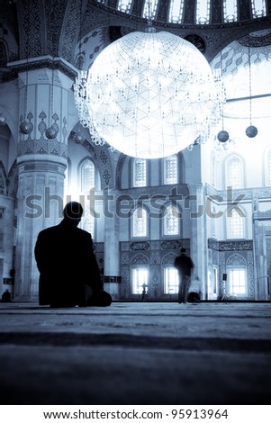 Praying Muslim man  silhouette in Kocatepe Mosque - Ankara, Turkey - Split toned