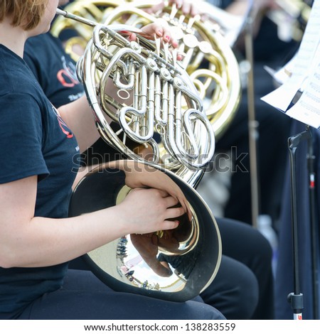 Playing French Horn instrument