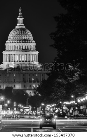Washington DC, United States Capitol building night view from from Pennsylvania Avenue with car lights trails - Black and white