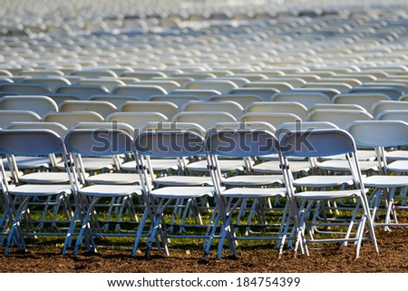 Rows of portable plastic chairs prepared for a open air event
