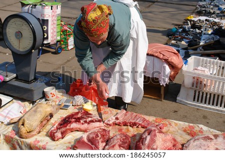 UKRAINE, KIEV - MARCH 31, 2007:  Meat seller in open air market.  Open air markets are still popular in Ukraine since it is important source of cheap and fresh products.