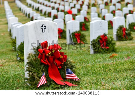 Gravestones with Christmas wreaths in Arlington National Cemetery - Washington DC United States