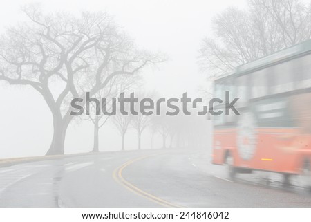 Washington DC in fog. A tour bus rides National Mall in motion blur