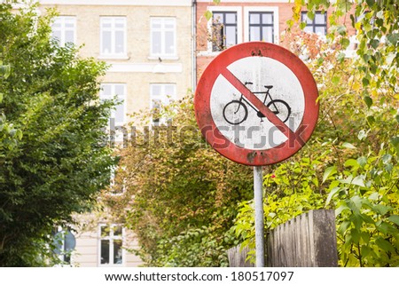 no bikes here: rusty and dirty traffic sign prohibiting bikes circulation