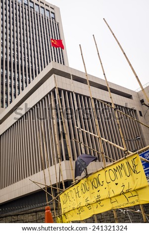 HONG KONG - December 3, 2014: protester\'s welcoming banner next to the flagged People\'s Liberation Army Hong Kong Garrison headquarter building, on day 68 of the pro-democracy protests