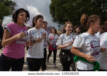 MILAN, ITALY - MAY 19: Avon running in Milan MAY 19, 2013. Thousands of women gather and run through the town not only for competition but also to promote a healthy and active lifestyle