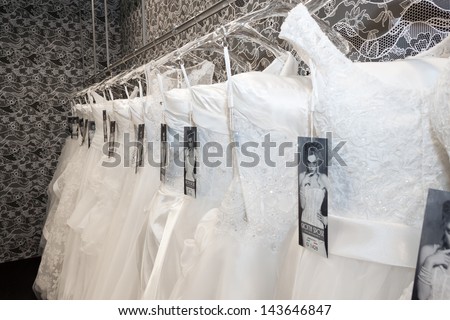 MILAN, ITALY - JUNE 21: White wedding dresses hung up in a stand at SposaItalia, international exhibition of bridal and formal wear according to Italian style, on JUNE 21, 2013 in Milan