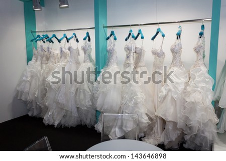 MILAN, ITALY - JUNE 21: Wedding dresses hung up in a stand at SposaItalia, international exhibition of bridal and formal wear according to Italian style, on JUNE 21, 2013 in Milan