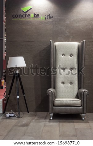 MILAN, ITALY - OCTOBER 3: Big armchair with lamp at Made expo, international architecture and building trade show on OCTOBER 3, 2013 in Milan.