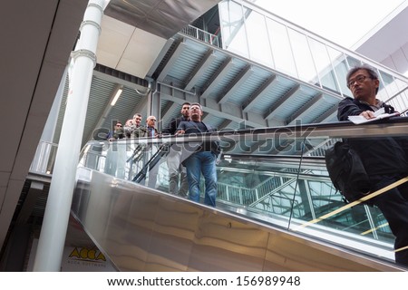 MILAN, ITALY - OCTOBER 3: People on escalator at Made expo, international architecture and building trade show on OCTOBER 3, 2013 in Milan.